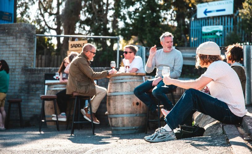 People sat in sunshine outside Cellar Door